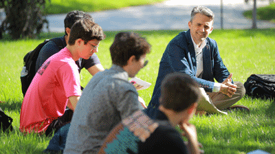 Students on lawn with professor McInnis